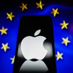 Apple logo is displayed on a smartphone with a European Union flag in the background.