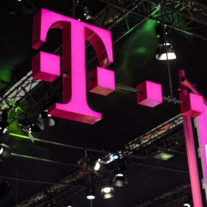 A large T-Mobile logo and a 5G poster hanging above a conference hall.