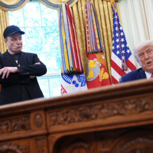 WASHINGTON, DC - MAY 30: Tesla CEO Elon Musk listens as U.S. President Donald Trump speaks to reporters in the Oval Office of the White House on May 30, 2025 in Washington, DC. Musk, who served as an adviser to Trump and led the Department of Government Efficiency, announced he would leave his role the Trump administration to refocus on his businesses.